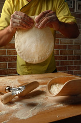 The chef prepares dough for fettuccine , soup and pizza