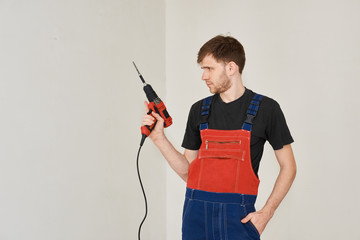 Wire electric screwdriver in hand