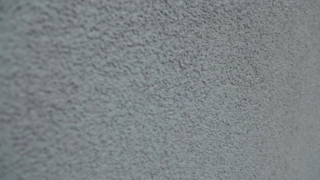 The wall is painted in gray plaster