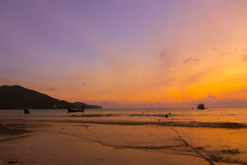 people on the beach during sunset time or silhouette