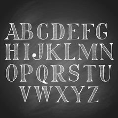 Hand drawn latin chalk vintage alphabet, set of black upper-case capital letters, isolated on blackboard background.