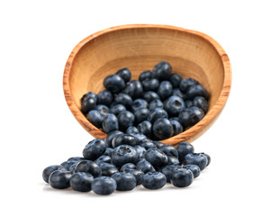 Blueberries in wooden bowl on white background