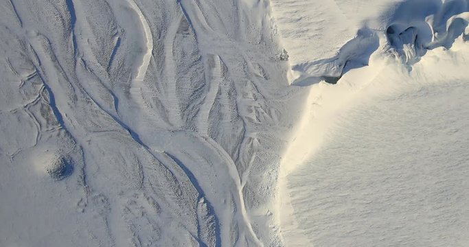 Very high-altitude overflight aerial of melt channels on Ellesmere Island, Canadian Arctic. Clip loops and is reversible. Elements of this image furnished by USGS/NASA Landsat