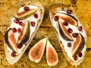 Soft Ricotta Cheese with Figs and Pomegranate Seeds on Toasted Ciabatta Bread