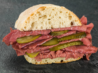 Salt Beef or Pastrami With Gherkins in a Ciabatta Bread Roll or Bun