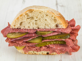Salt Beef or Pastrami With Gherkins in a Ciabatta Bread Roll or Bun