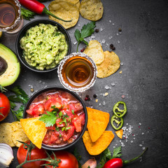 Latinamerican food party sauce guacamole, salsa, chips and tequi