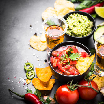 Latinamerican food party sauce guacamole, salsa, chips and tequi