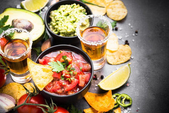 Mexican food party sauce guacamole, salsa, chips and tequila. Latin food.