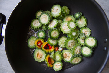 Cooked bitter melon, momordica charantia in pan. Home cooked indian vegetable stew. Appetizer for gourmet. Vegan and vegetarian food. Selective focus.