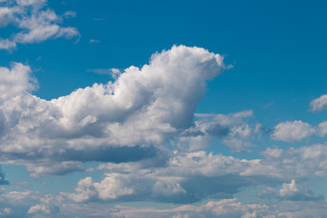 White clouds on a blue sky. The blue sky