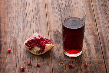 Pomegranate juice on a wooden background
