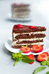 Appetizing slice of pie, with strawberries and mint leaves on white background