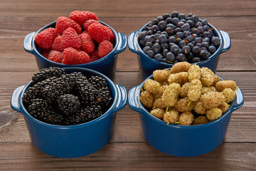 four bowls with berries