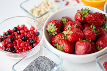 fruits and berries in bowls on table