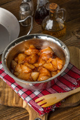 Chunks of chicken in marinade.