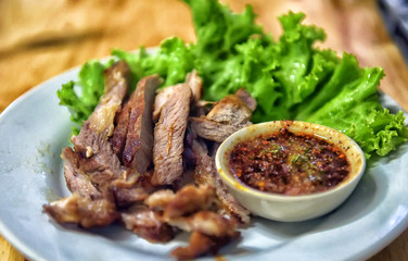 Grilled meat and sauce in a bowl