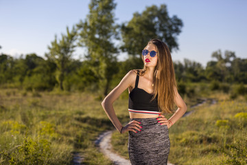 Young woman with sunglasses on a country lane