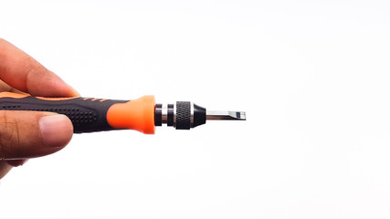 Man's hand holding screw driver with orange color handle