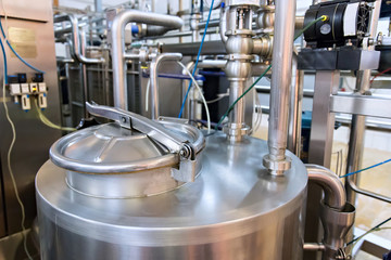 Industrial dairy production. Storage steel tanks on the milk factory.