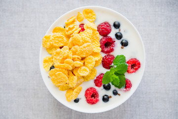 tasty breakfast with cereals and yoghurt raspberry