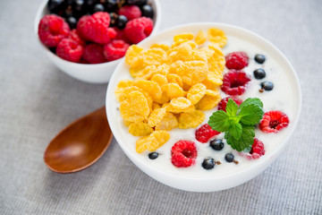 tasty breakfast with cereals and yoghurt raspberry