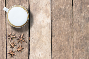 Mock up hot coffee and anise on plank wood. top angle view. copy space