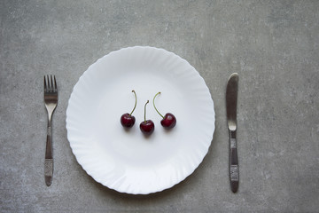 Cherries on the white plate