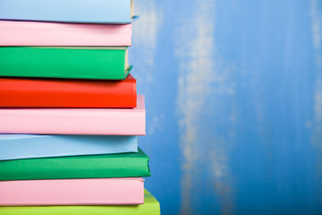 Stack of books on a blue background.
