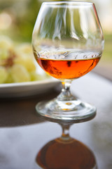 Cognac in a glass with grapes