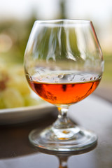 Cognac in a glass with grapes