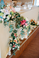 Candles with decor and flowers, peach, white and green color