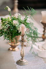 Candles with decor and flowers, peach, white and green color