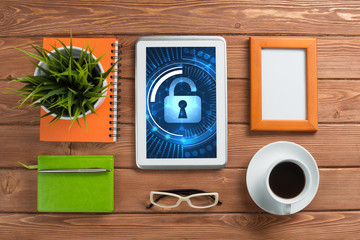 Web security and technology concept with tablet pc on wooden table