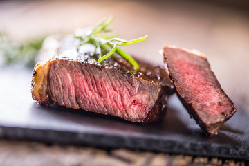 Grill juicy beef T-bone steak with salt pepper and rosemary
