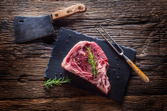 Beef raw steak. Raw fresh T-bone steak with salt pepper and rosemary