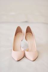 beige wedding shoes on a neutral light background