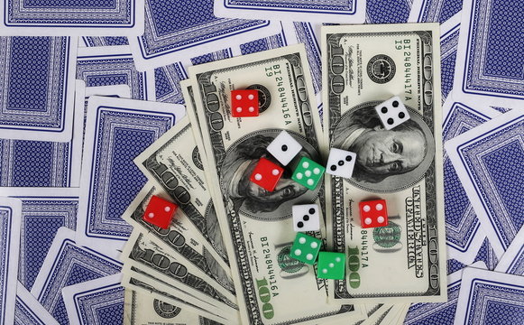 Gambling dice, hundred dollar bills and cards background and texture