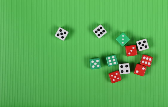 Gambling dice on green background and texture