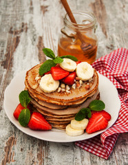 Pancakes with strawberries and bananas