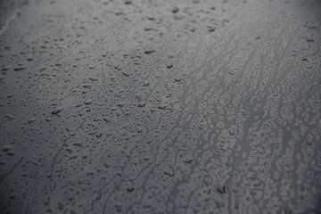 Drops of water at car hood, background