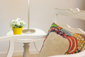 Nightstand with flower vase and Armchair With Pillow