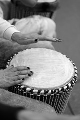 Ethnic drum in the hands of the participant of the percussion music concert during the performance of the composition.