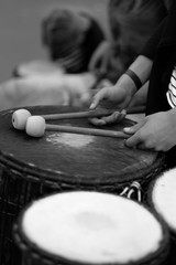 A drummer with chopsticks behind a percussion set at a concert of percussion music.