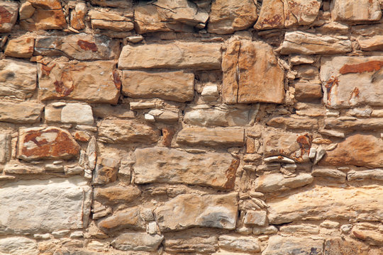 The detail, close up of the sandstone brick wall. The texture of the sandstone. It can be useld as the background.