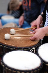 A drummer with chopsticks behind a percussion set at a concert of percussion music.