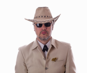 Studio portrait of a cowboy in a white suit