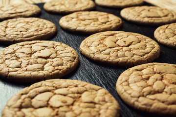 Biscuit sweet cookie background. Domestic stacked butter biscuit pattern concept,close up macro.Homemade cookies on wooden table.Cereal biscuits with the sesame,peanuts,sunflower and amaranth.