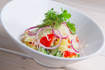 Salad with fresh bell pepper, cucumber, red onion, boiled potato and cheese