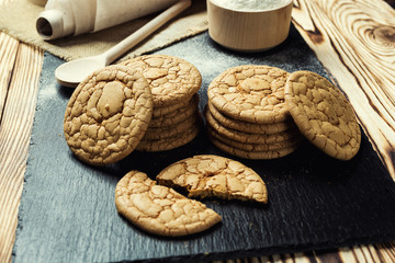Biscuit sweet cookie background. Domestic stacked butter biscuit pattern concept,close up macro.Homemade cookies on wooden table.Cereal biscuits with the sesame,peanuts,sunflower and amaranth.